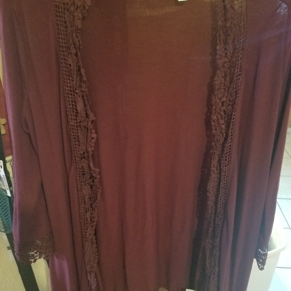 Maroon colored open cardigan.